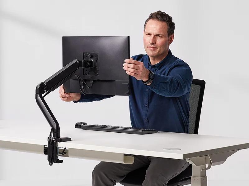 Monitor arm improving posture at a desk