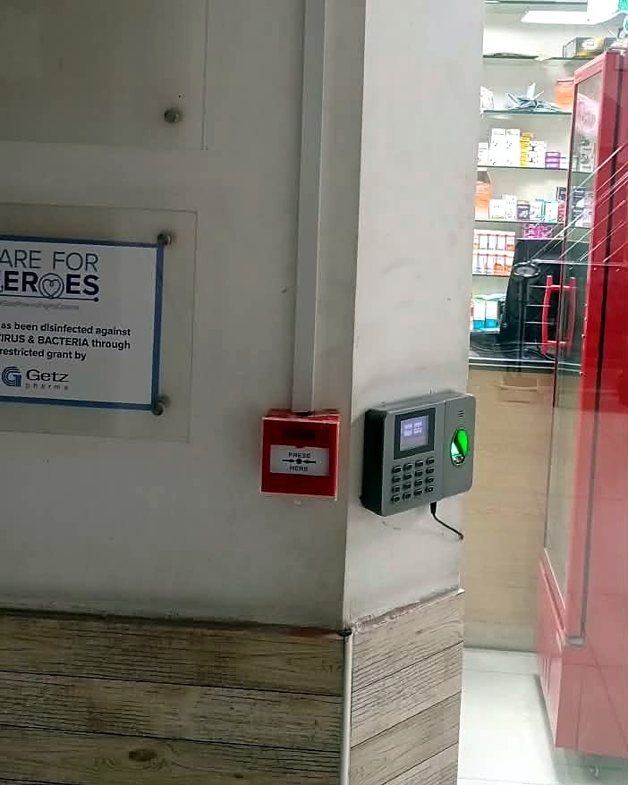 Manual call point on the pillar outside the hospital pharmacy