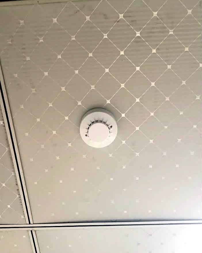 Global smoke detector fitted flush into a ceiling tile