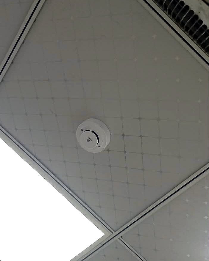 Smoke detector fitted into the false ceiling of a hospital room